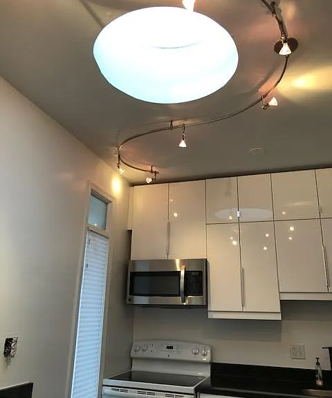 Ceiling height cabinets in kitchen. Round skylight (one of three) and a pantry.