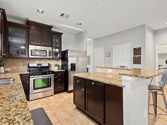 The kitchen has plenty of cabinet and counter space. The island is perfect for dining or visiting with the chef.