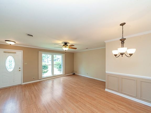 Another look at the newer light fixtures, flooring and rich looking crown molding