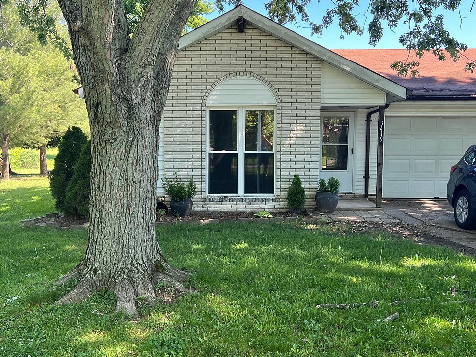Front of condo with attached one car garage.
