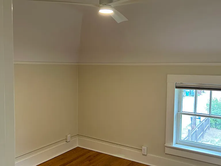 new paint in bedroom. Ceiling is 8' with angled walls. New ceiling fan in 2024