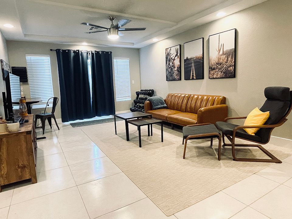 Wonderful fully-furnished Living Room. Complete w/ couches, workout area, adjustable height desk, TV, kitchenette, high speed wiFi, and patio door leading to private backyard.