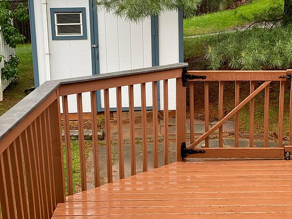 Back deck newly stained with shed