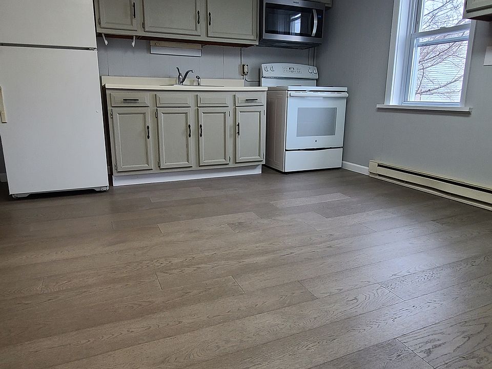 Kitchen, hardwood flooring throughout - includes refrigerator, stove, microwave & plenty of space for table and eat-in area