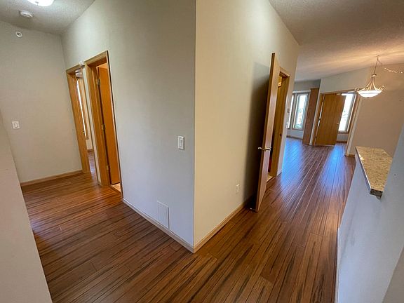 Left: both bedrooms and bathrooms. 1x bathroom with tub is on right. 1x bathroom is in the primary suite.