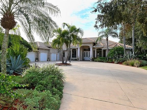 Attractive entrance with lush, mature tropical landscaping - seller is a Master Gardener and it shows!