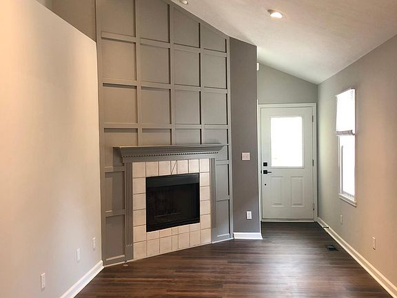 Custom fireplace wall. LED lighting. New fixtures. High ceiling.