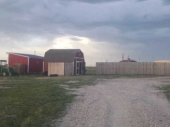 View from drive of shed and barn