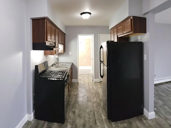 Brand New Kitchen Featuring Black Appliances