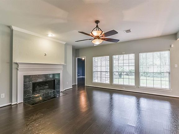 18x16 Family Room - Even on a cloudy day this home is bright and cheerful! The fireplace with wood trim surround and mantle anchors the room.