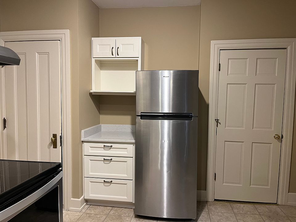 microwave cabinet with door to pantry and bedroom