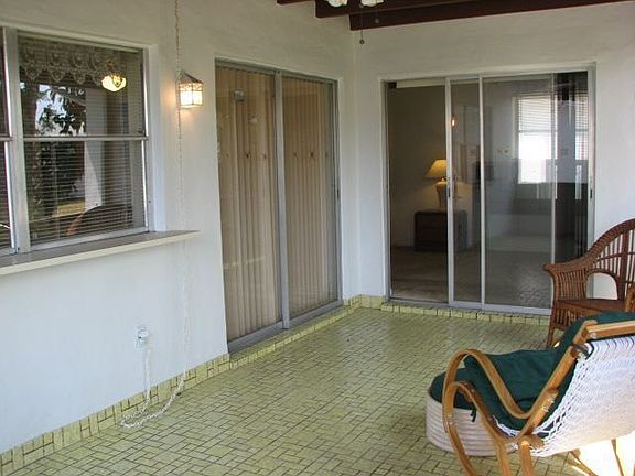 Covered screen enclosed patio with garden view 