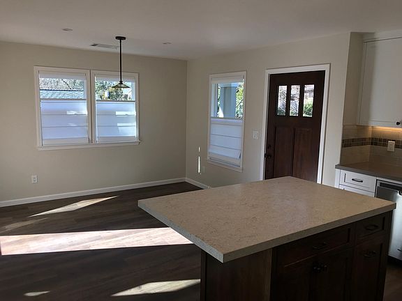 Dining room (with French door access to deck (not visible). Window coverings on all windows and doors.