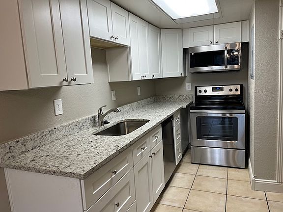 Kitchen with new cabinets (soft close doors and drawers), granite countertops, large/deep single hole Stainless sink w/ garbage disposal, dishwasher, microwave, stove and refrigerator.