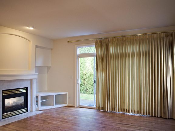 Bright family room with TV corner and fireplace