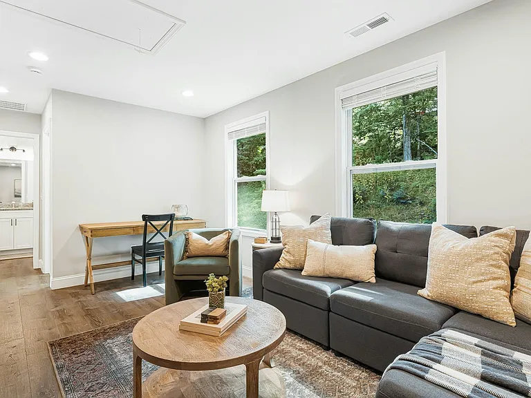 Upstairs living room, sectional seating perfect for movie nights, windows look to rear of house