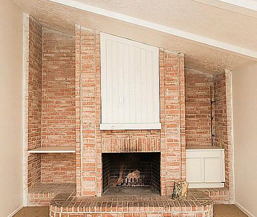 Floor to ceiling fireplace in family room with built ins.