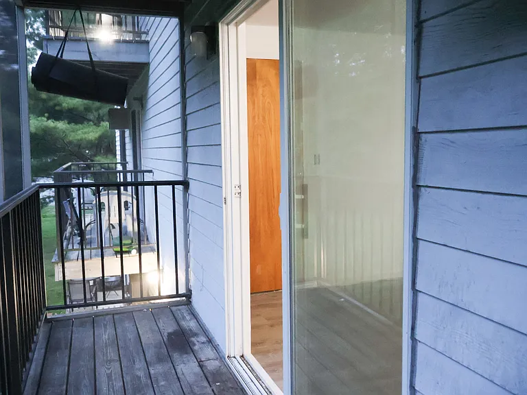 Private Balcony _ Accessible Directly from the Living Room and Overlooking the Backyard. Fully Enclosed with Protective Screening for Added Safety for Children while also helping keep mosquitoes and other insects out.