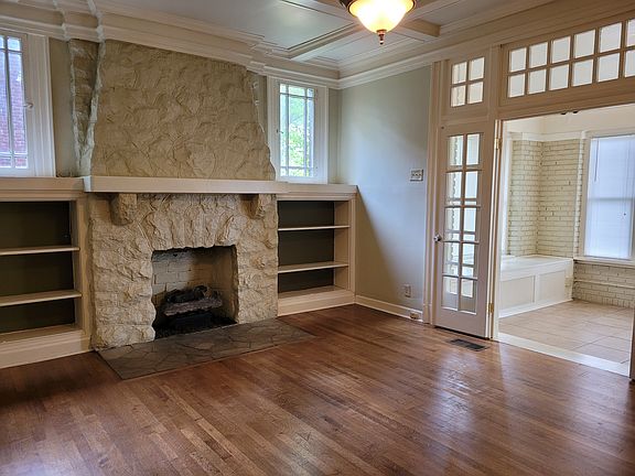 Living room with stone gas fireplace and built-ins