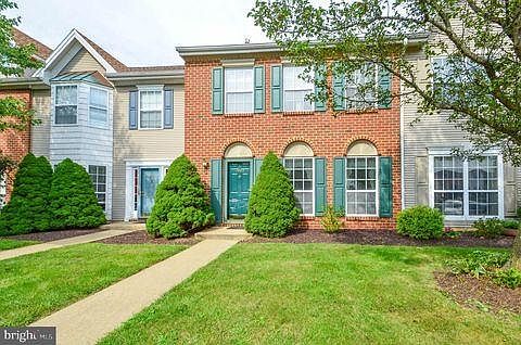 Center unit, with brick facade.