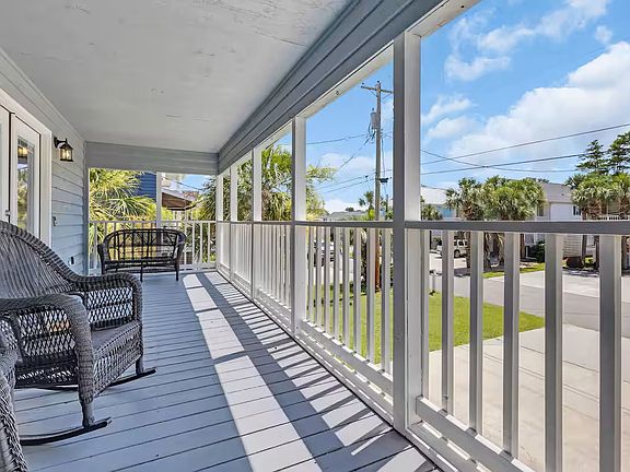 Walk up the stairs to a large porch and separate living area for the 3 bedroom house.