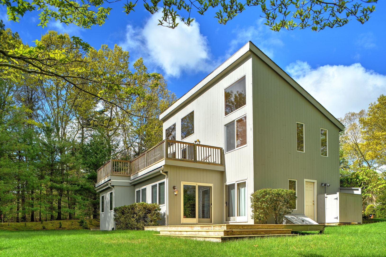  Rear of Home with Top and Bottom Decks Facing the Pond