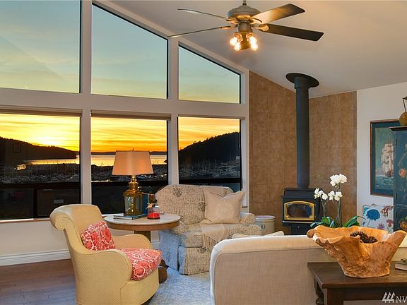 Gorgeous sunset view looking out the living room area with wall of windows, overlooking the marina.  