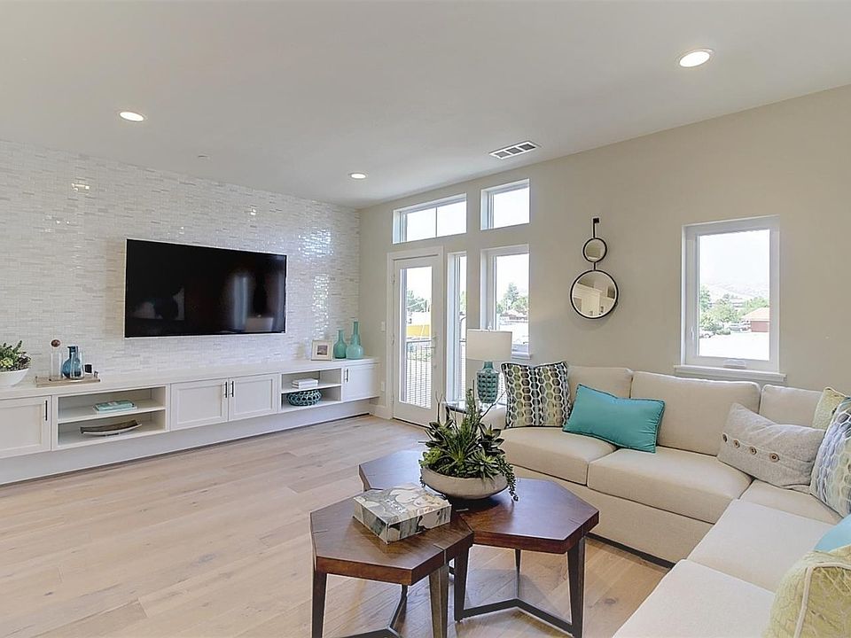 Living room with a door that opens to the front balcony.