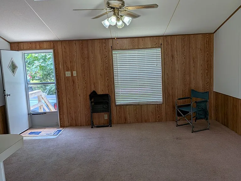 Living room, view to front entry storm door, ceiling fan, central AC, all electric