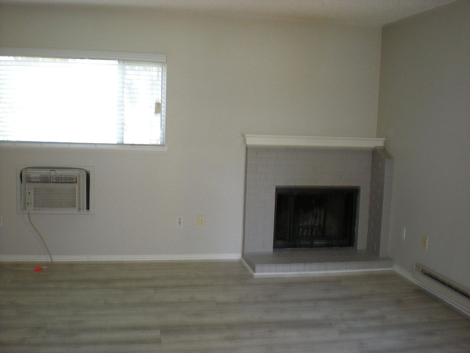 Contemporary colors, wood burning fireplace and custom blinds