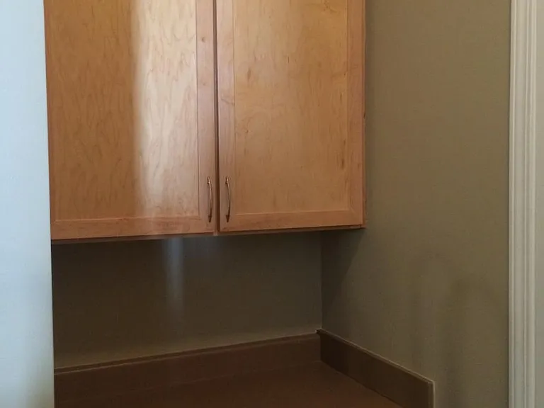 Extra counter and cabinet space (Some people use this as a desk or a bar area.) There is a coat closet directly across from it.