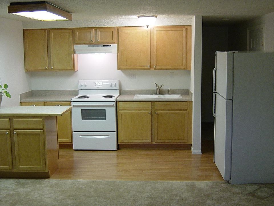 Maple kitchen cabinets, small eat in counter, full size stove, refrigerator and double sink. Faux hardwood flooring in the kitchen area. Small 6x12 bedroom located behind the kitchen.