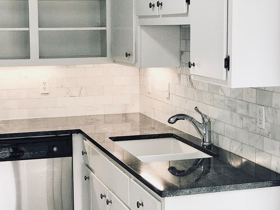 Updated kitchen with Carrera marble backsplash and black gra