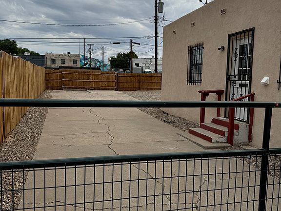 Side of the house, gated driveway.