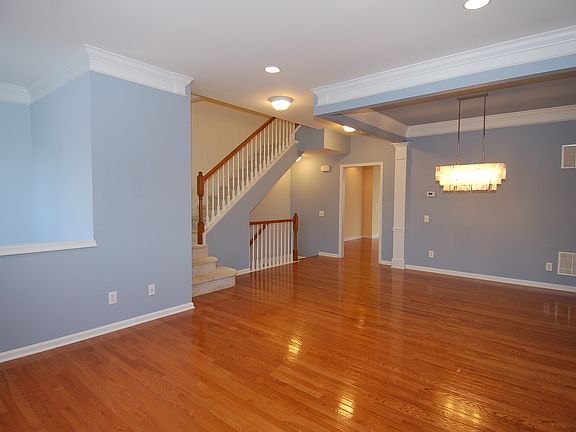 Hardwood floors and crown molding accent this combo living/d