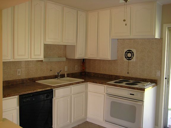 Remodeled Kitchen with new cabinets, countertops, and tile backsplash.