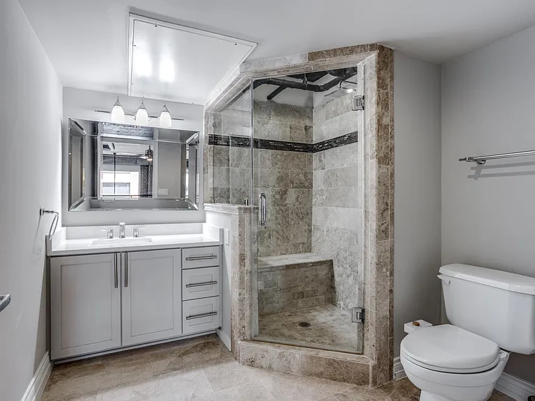 Step into luxury with marble floors and a walk-in shower in this spa-inspired bathroom, perfect for a refreshing start or end to your day.