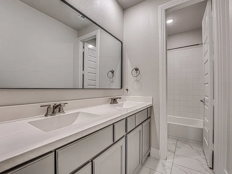 Bathroom featuring a double vanity with integrated rectangular sinks and brushed nickel faucets