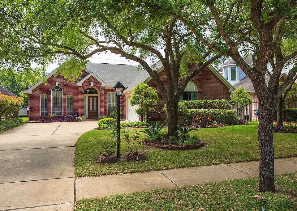 Front yard with lush landscaping and ample shade