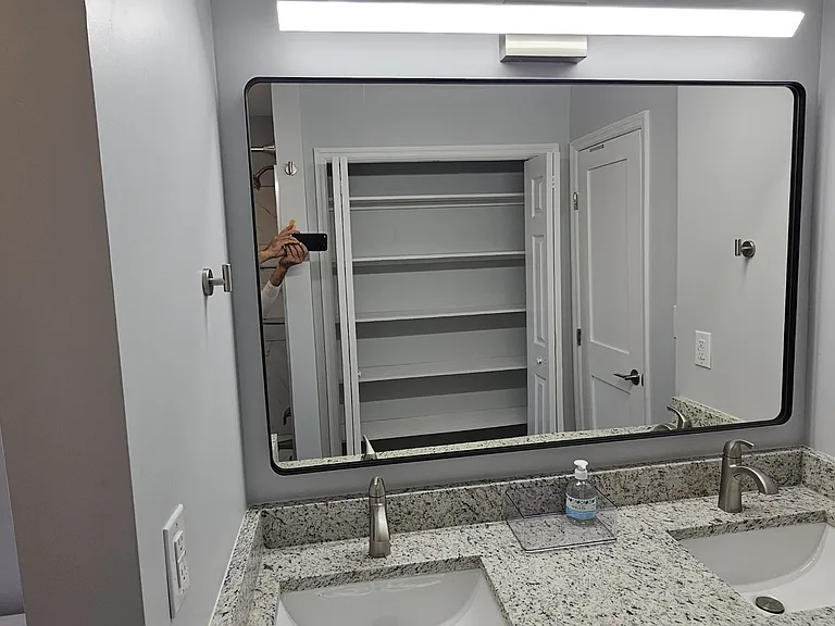 Upstairs bathroom - with lots of shelves shown in the mirror