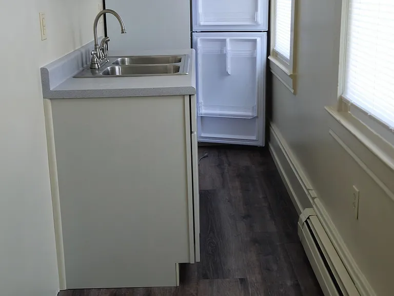 A galley kitchen with lots of natural light. A new kitchen spigot and base, new refrigerator, a new stove arrives on June 16th, and new flooring. Drawers in base and stove. Room for a small table for a microwave.
Baseboard clean heat throughout.
