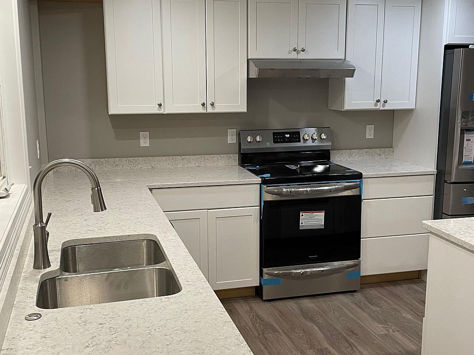 Kitchen with quartz counters and island with seating