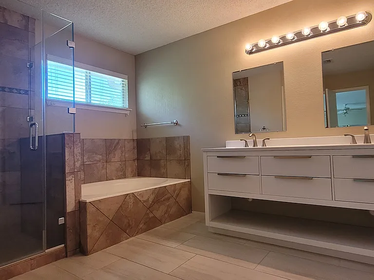 Large master bathroom with shower, tub, and 2 closets.