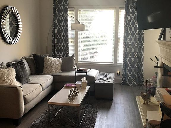 Ample living room space with fireplace.