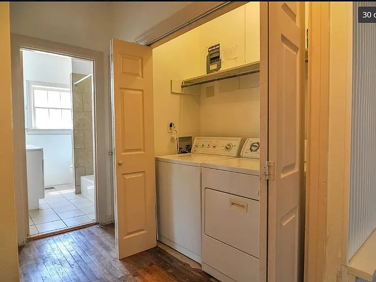 Utility closet in hallway, pictured before painting and replacing the dryer