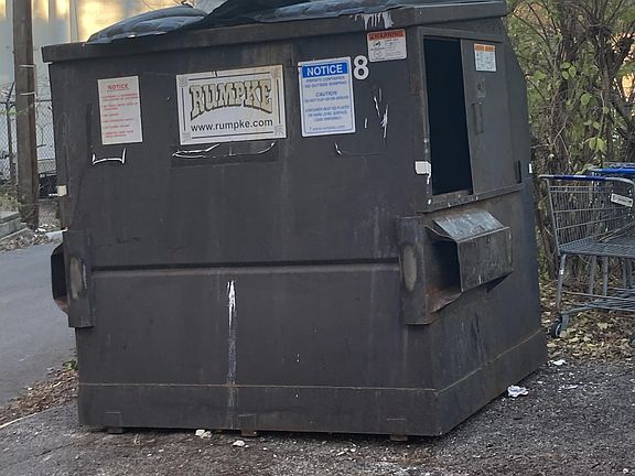 2512-2516 Highland, Rumpke dumpster @ side of bldg, outside of fencing