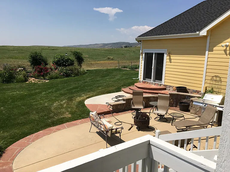 Shared back patio with fire bowl. Looking south over the Cathy Frome prairie.