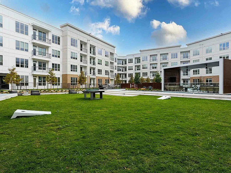 Spacious lawn meets city living.