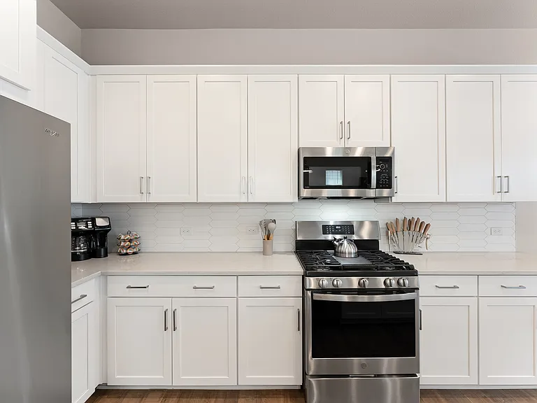 Modern, bright kitchen with stainless steel appliances, spacious countertops, and ample storage. Ideal for cooking during long stays. Your home away from home!