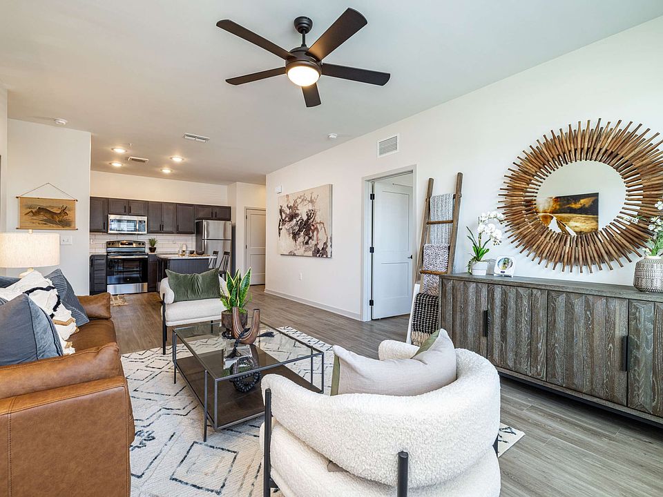 Open concept apartment floorplans with ceiling fans in living rooms at The Groves at Lake Juliana